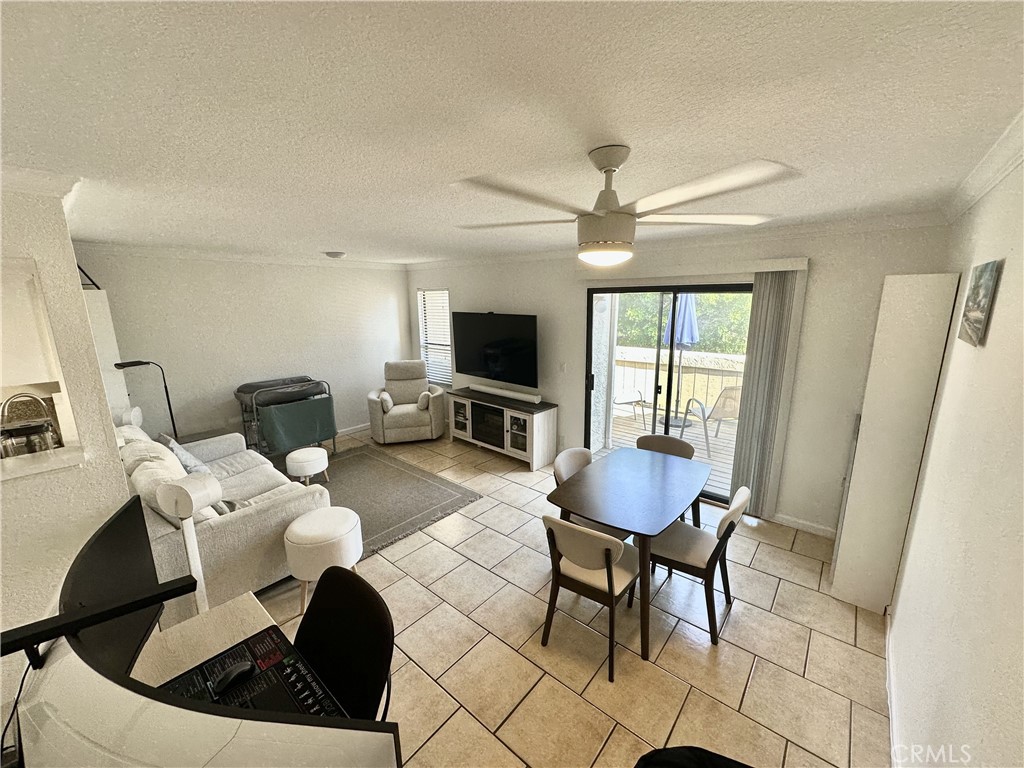 a living room with furniture a flat screen tv and a window
