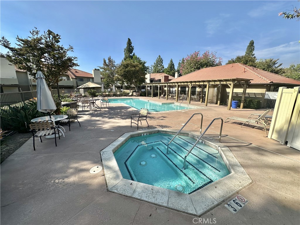 10151 Arrow, Unit 6 Rancho Cucamonga, CA 91730 - Photo 16 of 19 a view of a swimming pool with a patio