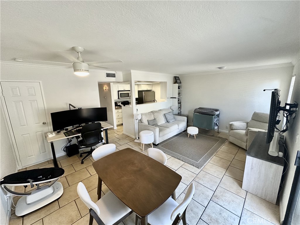10151 Arrow, Unit 6 Rancho Cucamonga, CA 91730 - Photo 2 of 19 a living room with furniture and a flat screen tv