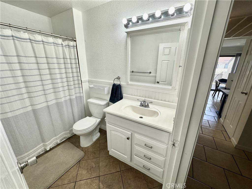 10151 Arrow, Unit 6 Rancho Cucamonga, CA 91730 - Photo 6 of 19 a bathroom with a sink a toilet and shower