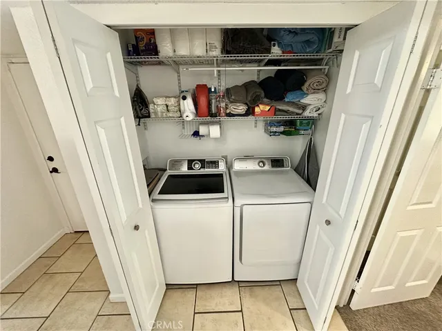 a bedroom with a bed and a large mirror