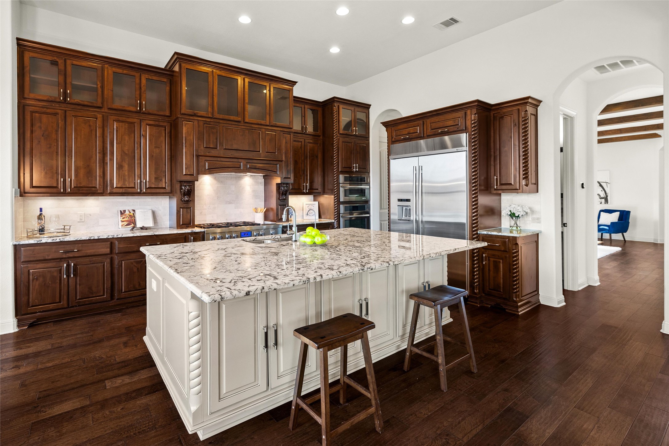 6000 Osceola Trail Austin, TX 78738 - Photo 14 of 40 a kitchen with granite countertop wooden floors and wooden cabinets