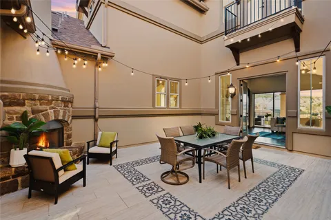 a view of a patio with table and chairs and potted plants