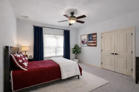 a bedroom with a bed and a chandelier