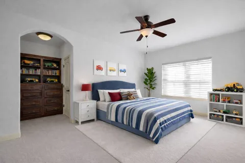 a bedroom with a bed closet and a window