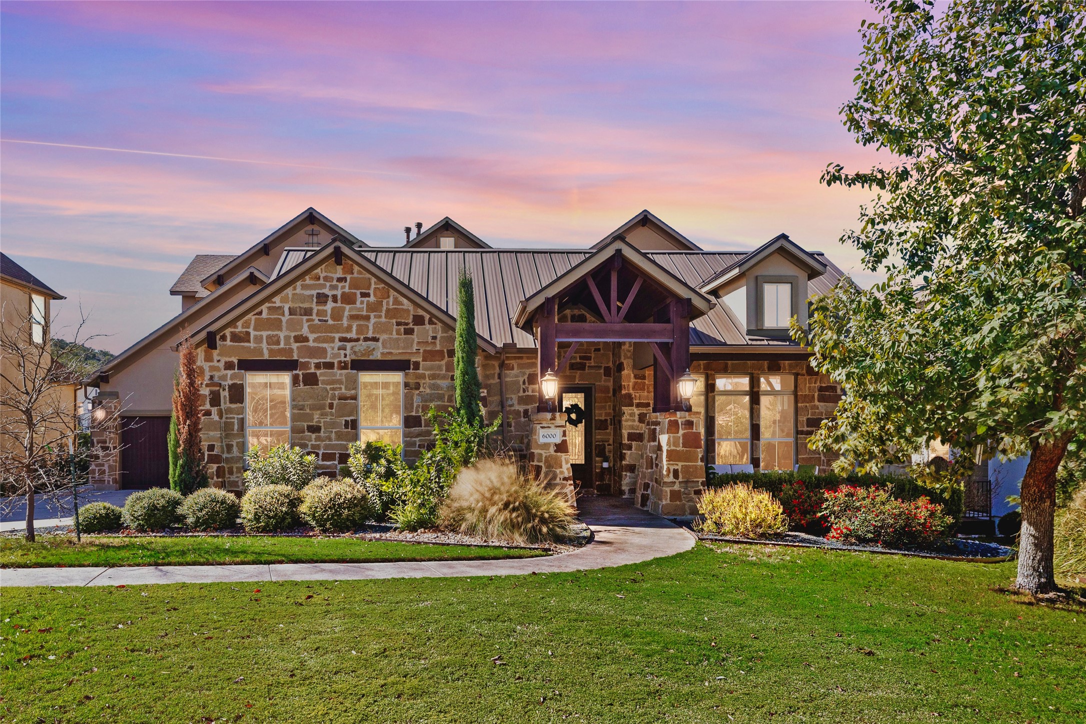 6000 Osceola Trail Austin, TX 78738 - Photo 3 of 40 a front view of a house with a garden