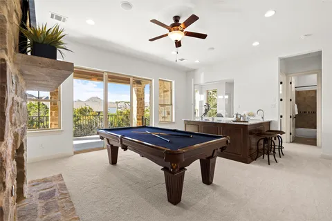 a living room with a table chairs and a large window
