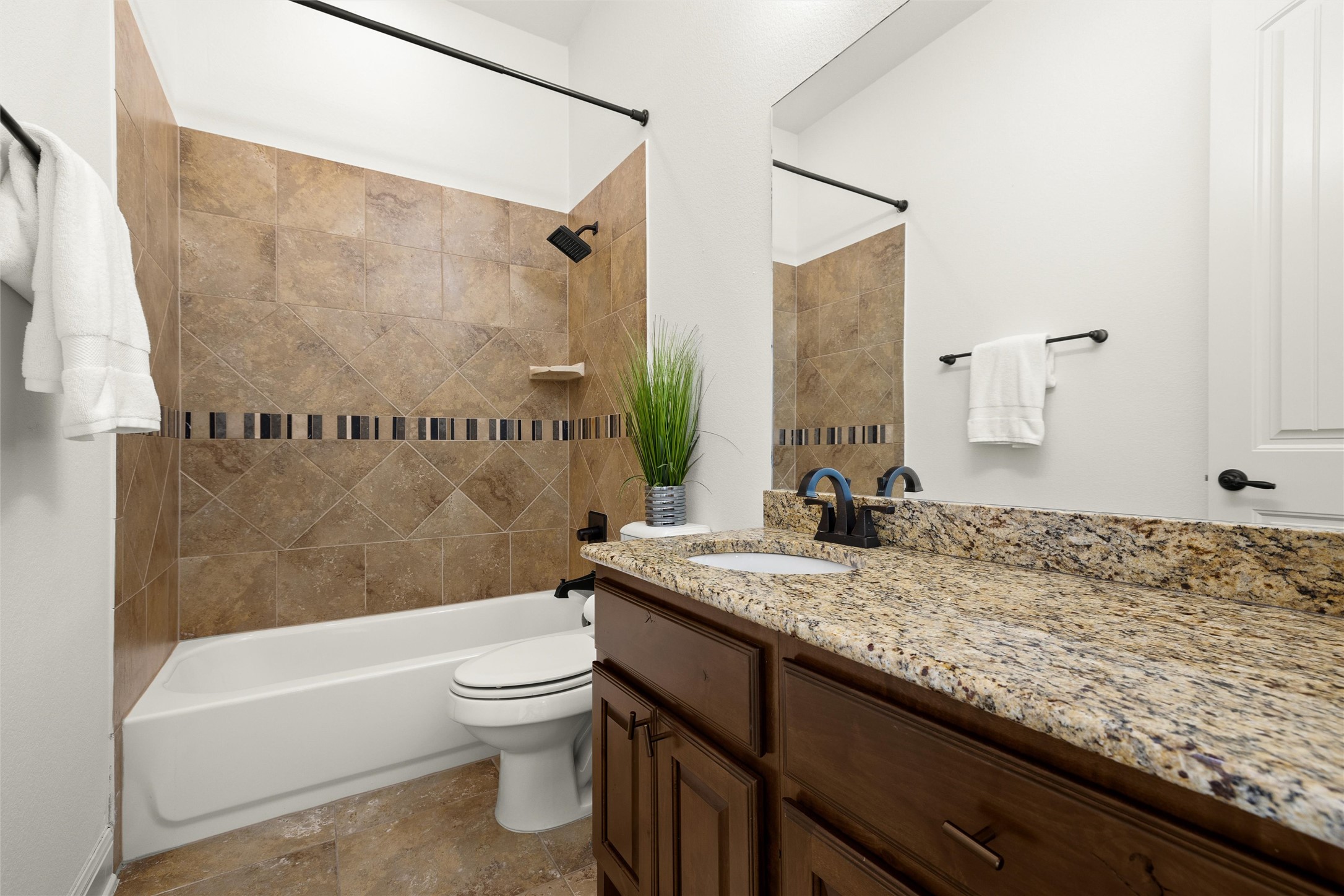 6000 Osceola Trail Austin, TX 78738 - Photo 35 of 40 a bathroom with a granite countertop sink a toilet and bathtub
