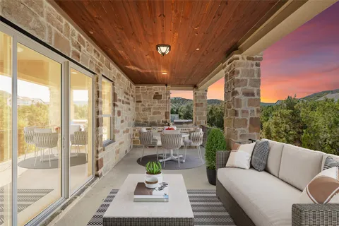 a living room with furniture and a floor to ceiling window