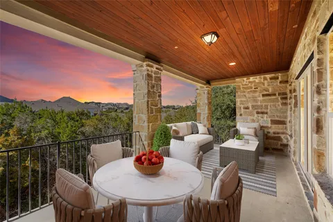 a view of a balcony dining table and chairs