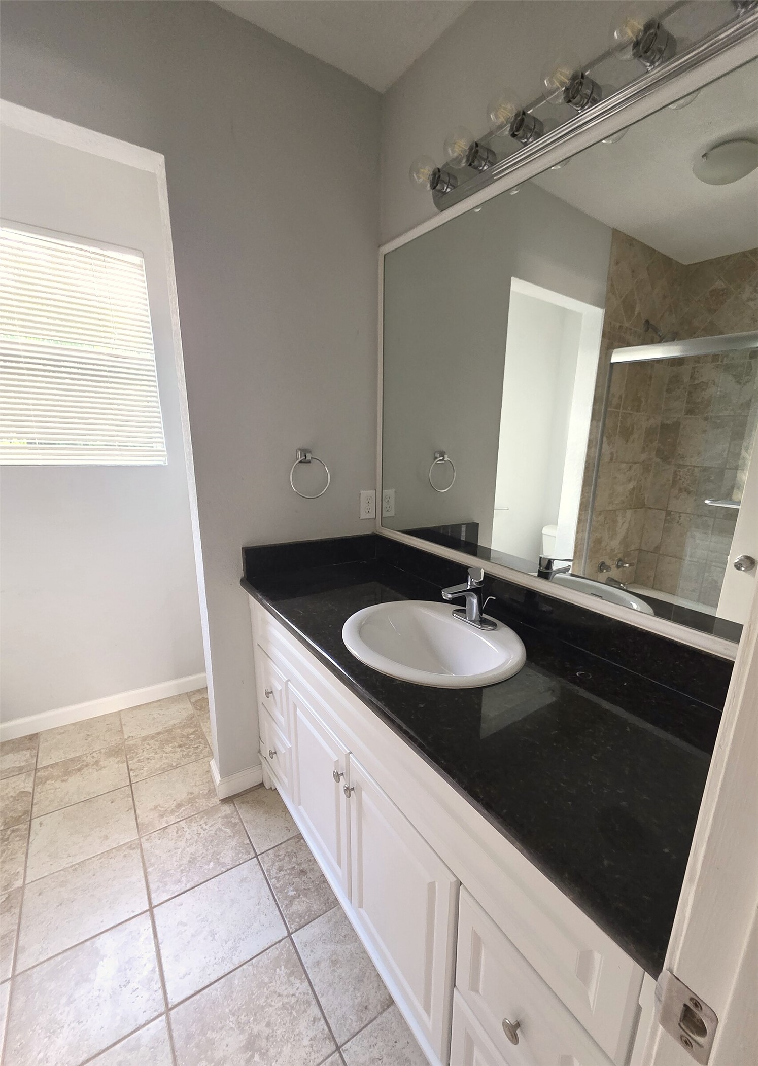 703 Castle Ridge Road, Unit B Austin, TX 78746 - Photo 12 of 18 Granite counters and tiled floors define this well-appointed bathroom space.