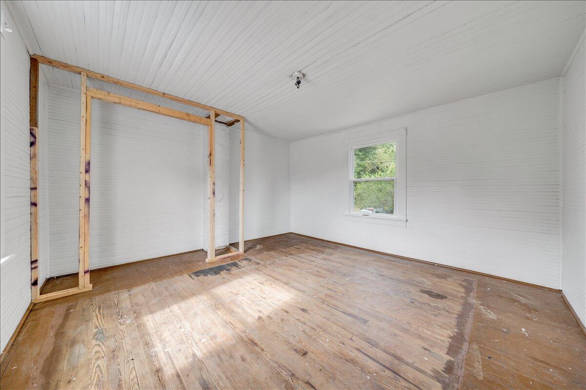 104 Claytor Road Brookneal, VA 24528 - Photo 12 of 43 an empty room with wooden floor and windows