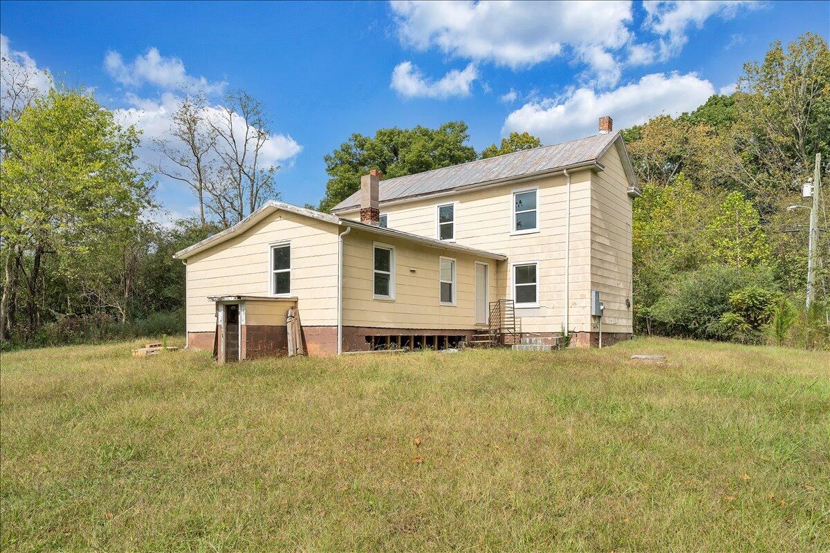 104 Claytor Road Brookneal, VA 24528 - Photo 22 of 43 a view of a white house with a big yard and large trees