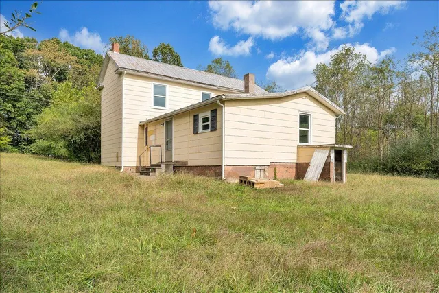 a view of a backyard with a garden and entertaining space