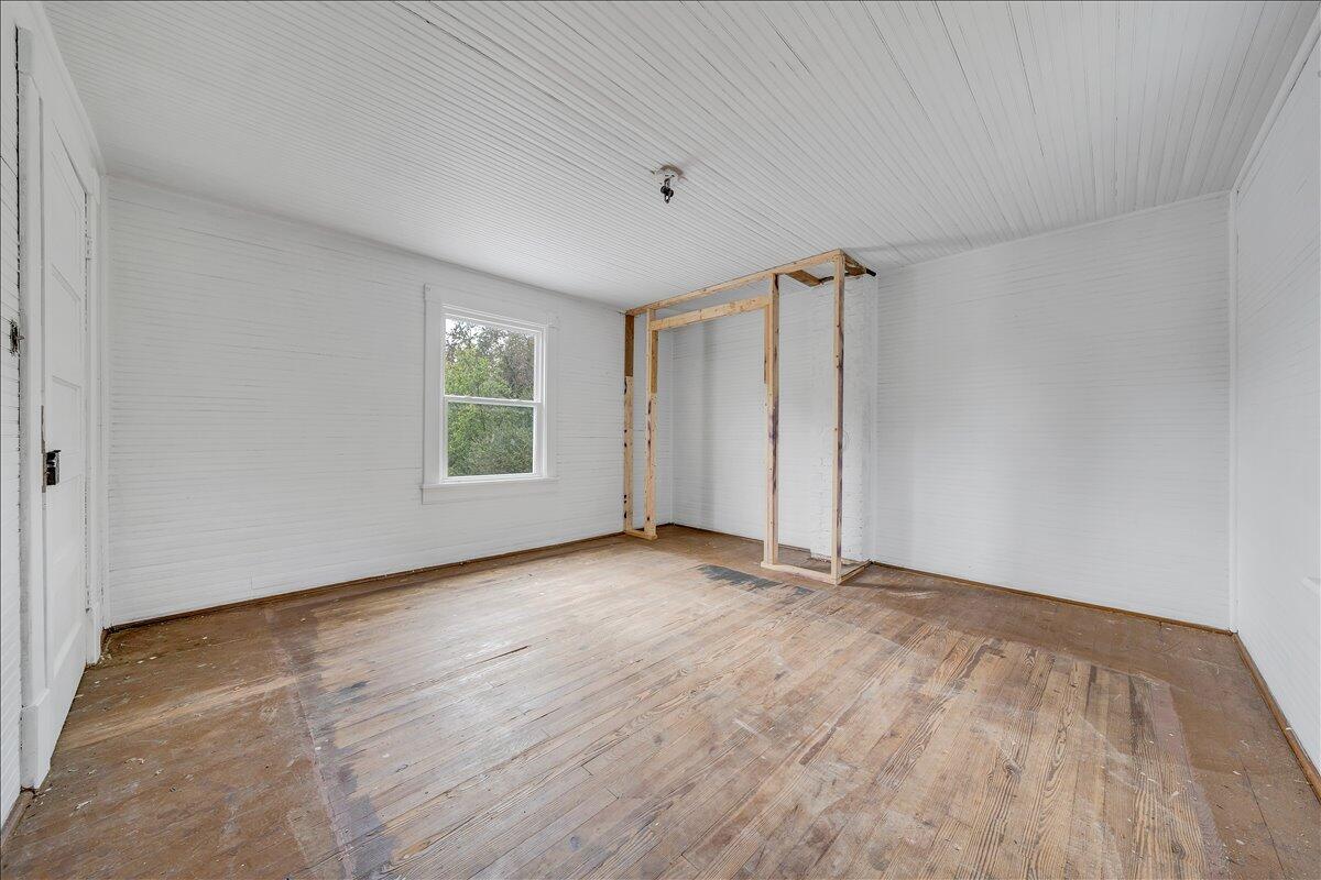 104 Claytor Road Brookneal, VA 24528 - Photo 10 of 43 a view of an empty room with a window and wooden floor