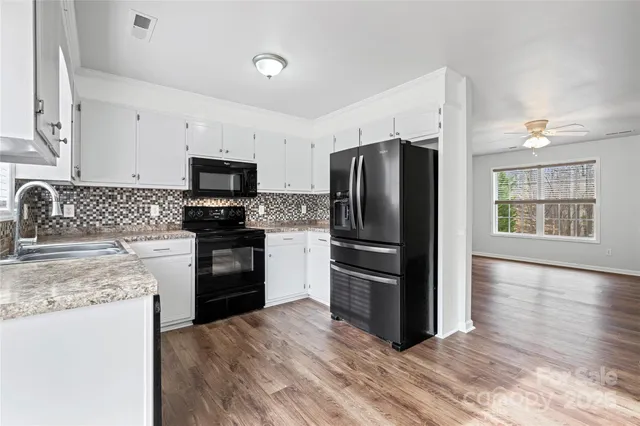 a view of a balcony with wooden floor and iron stairs