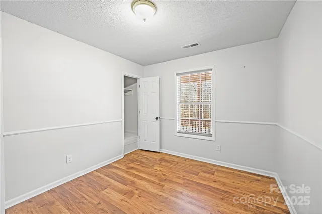 a view of a room with wooden floor and closet