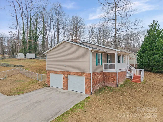 a view of a house with a yard and garage
