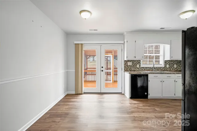 a kitchen with granite countertop a refrigerator stove and sink