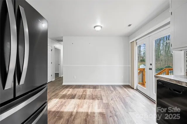a kitchen with granite countertop a refrigerator and a stove top oven