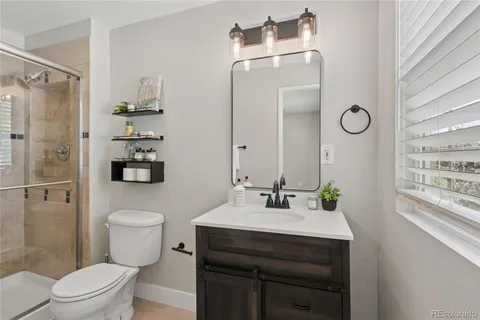 a bathroom with a shower a toilet and a shower