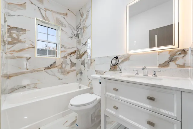 a bathroom with a sink a toilet and bathtub