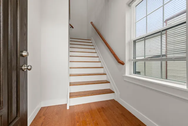 a view of entryway with wooden floor and stairs