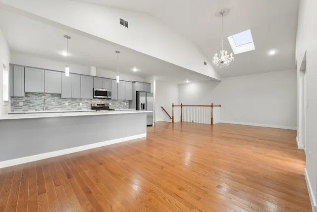 a view of kitchen with refrigerator microwave and stove