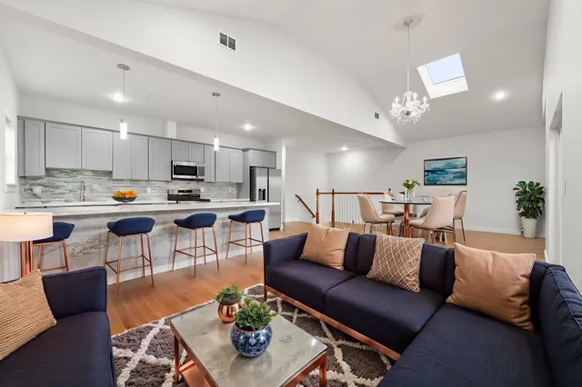 a living room with furniture kitchen and a table