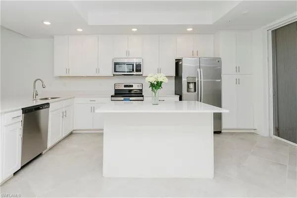 a kitchen with cabinets and stainless steel appliances
