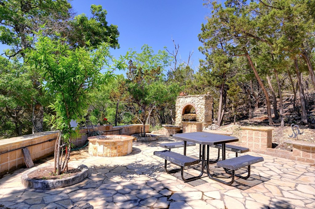 324 East Headwaters Ranch Road Kendalia, TX 78027 - Photo 41 of 61 a view of a chairs and table in a patio
