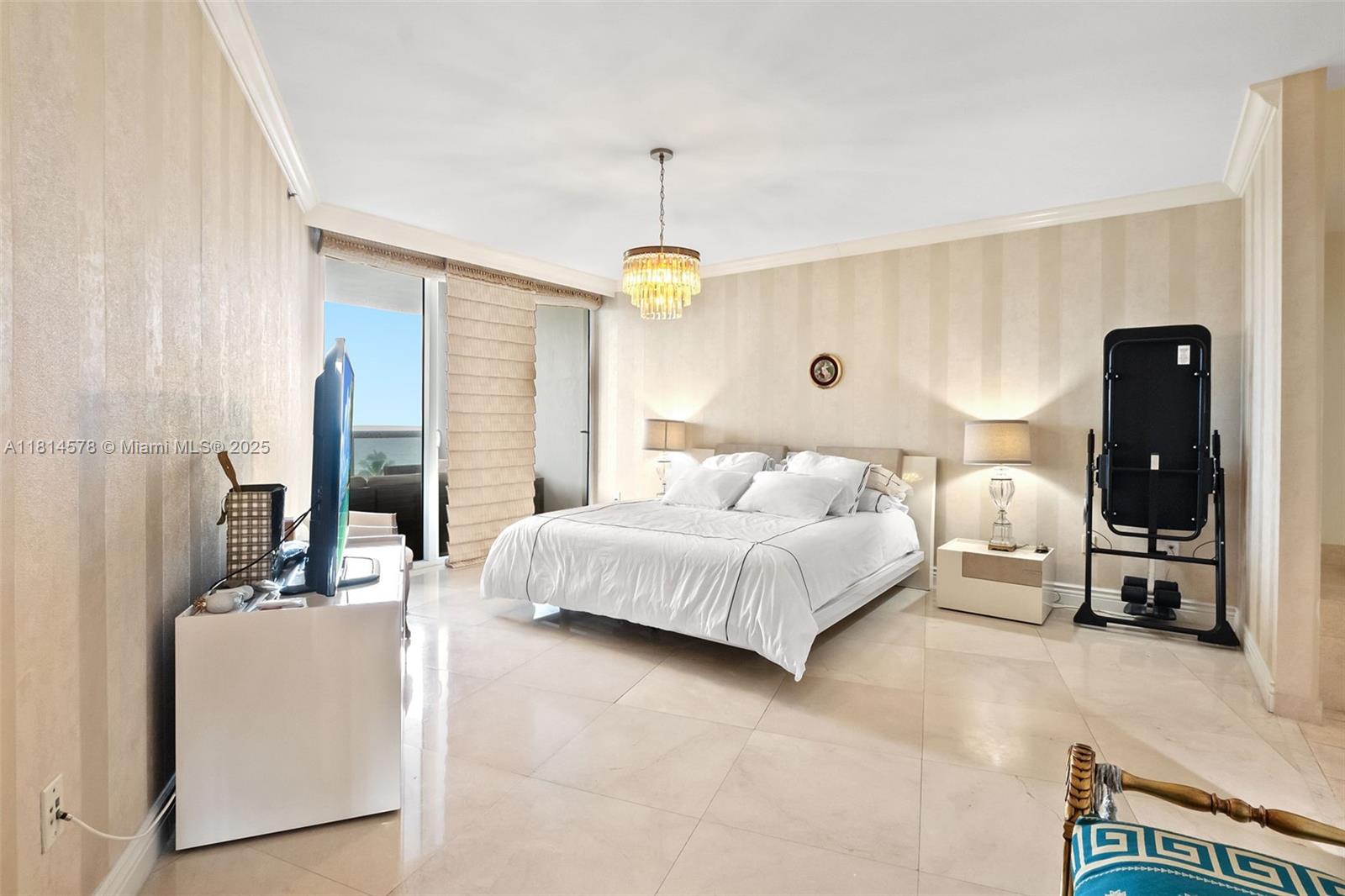 18911 Collins Avenue, Unit 706 Sunny Isles Beach, FL 33160 - Photo 15 of 28 a bedroom with a bed and a chandelier