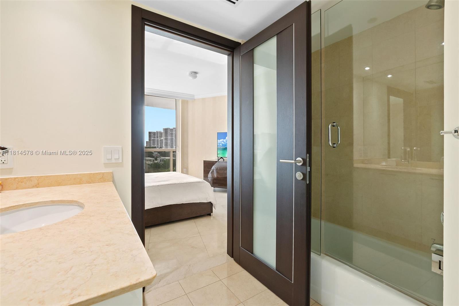 18911 Collins Avenue, Unit 706 Sunny Isles Beach, FL 33160 - Photo 24 of 28 a spacious bathroom with a tub and shower