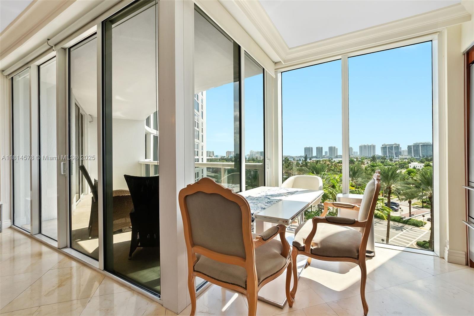18911 Collins Avenue, Unit 706 Sunny Isles Beach, FL 33160 - Photo 8 of 28 a view of a room with a table and chairs