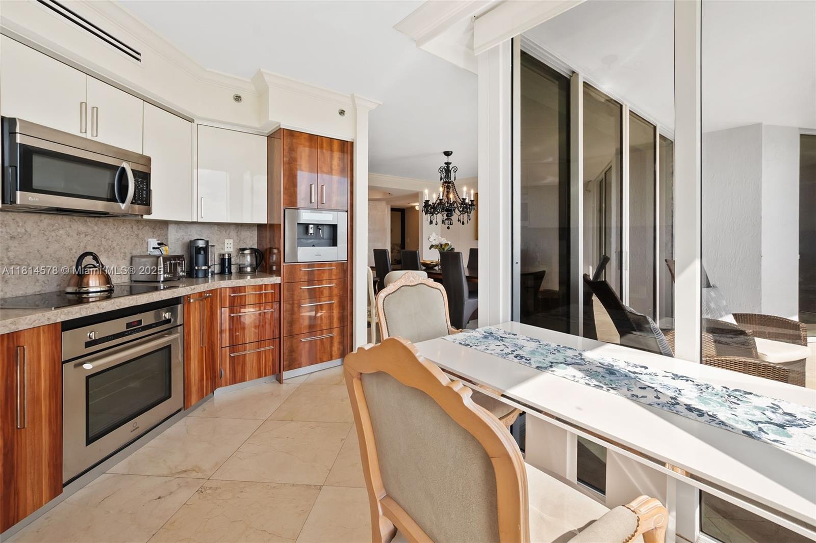 18911 Collins Avenue, Unit 706 Sunny Isles Beach, FL 33160 - Photo 9 of 28 a kitchen with stainless steel appliances granite countertop a refrigerator stove microwave and sink