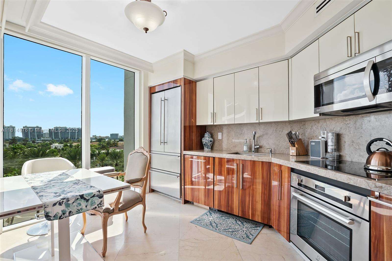 18911 Collins Avenue, Unit 706 Sunny Isles Beach, FL 33160 - Photo 10 of 28 a kitchen with stainless steel appliances granite countertop a stove a sink dishwasher and cabinets with wooden floor