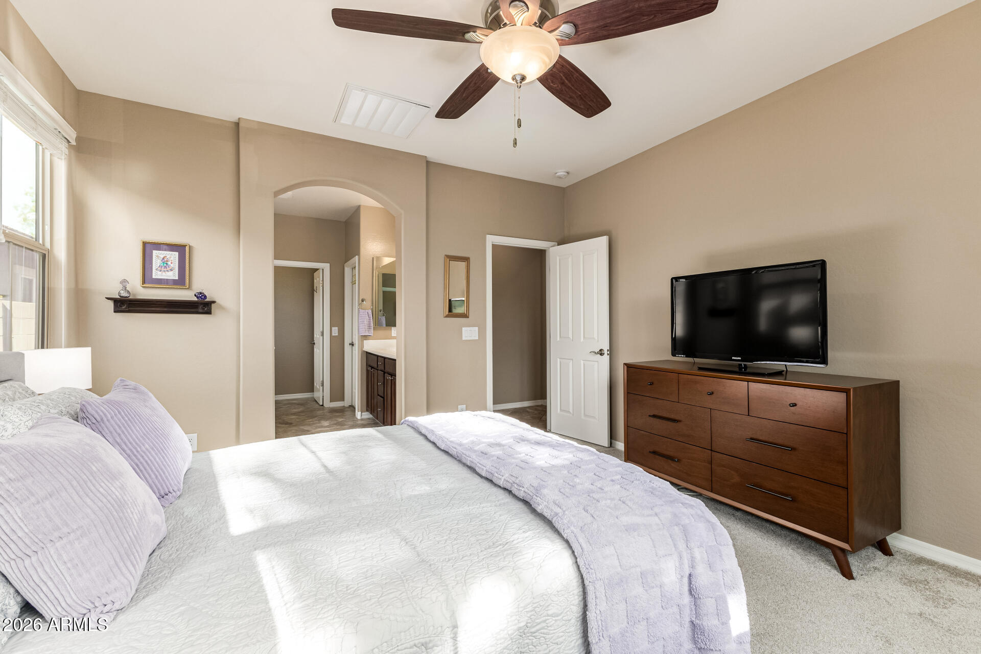 20594 West White Rock Road Buckeye, AZ 85396 - Photo 13 of 38 a bedroom with a bed and a flat screen tv