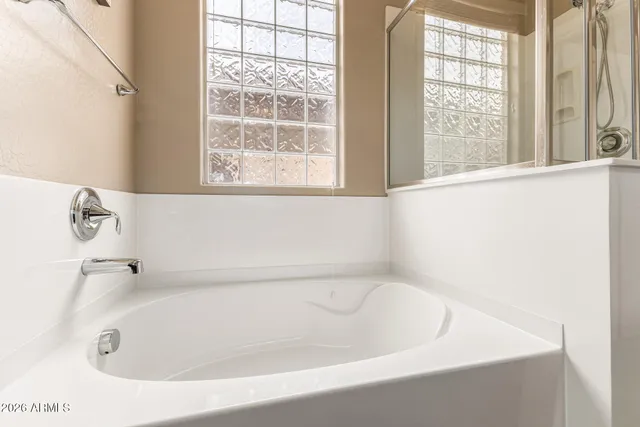 a white bath tub sitting next to a window