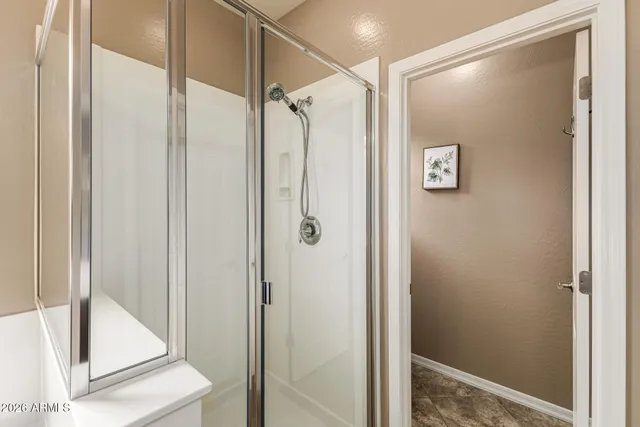 a bathroom with a glass shower door