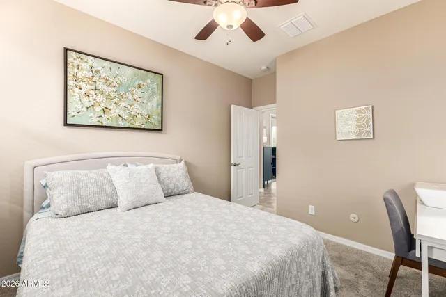 a bedroom with a large bed and a chandelier