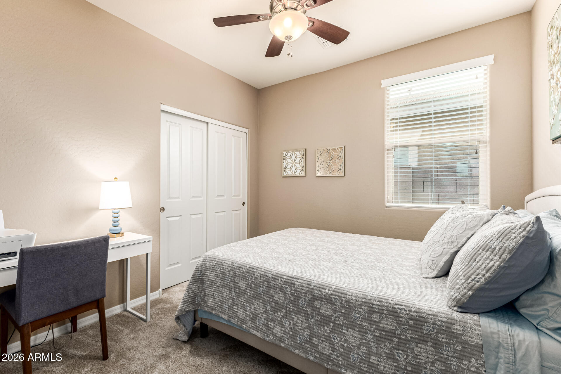 20594 West White Rock Road Buckeye, AZ 85396 - Photo 18 of 38 a bedroom with a bed a table and chair