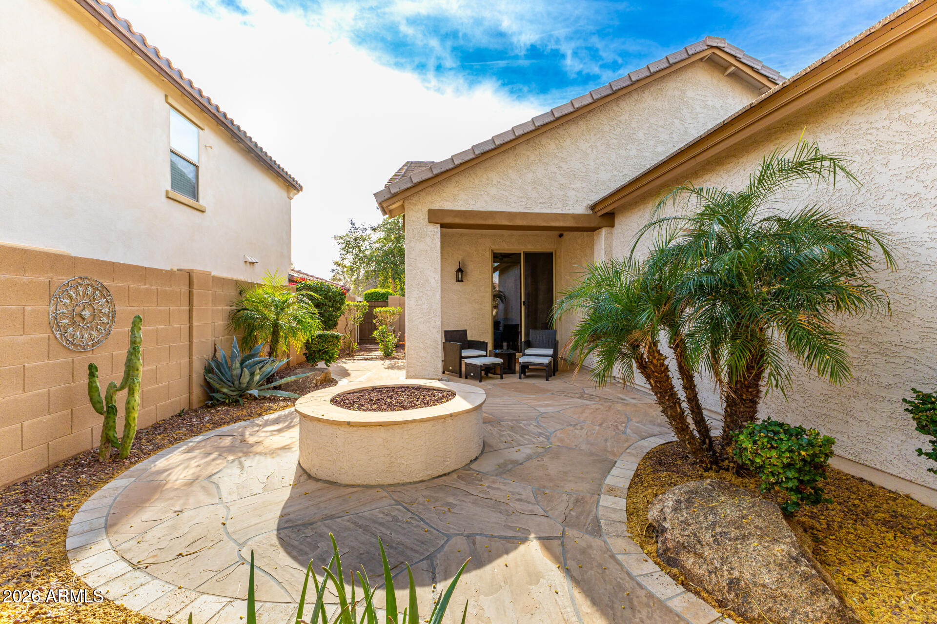 20594 West White Rock Road Buckeye, AZ 85396 - Photo 24 of 38 a view of a patio with table and chairs potted plants with wooden fence