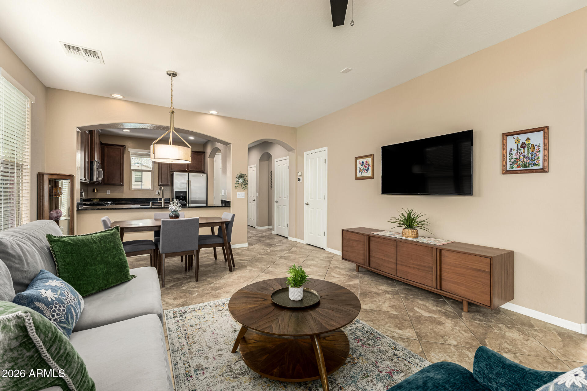 20594 West White Rock Road Buckeye, AZ 85396 - Photo 6 of 38 a living room with furniture and a flat screen tv