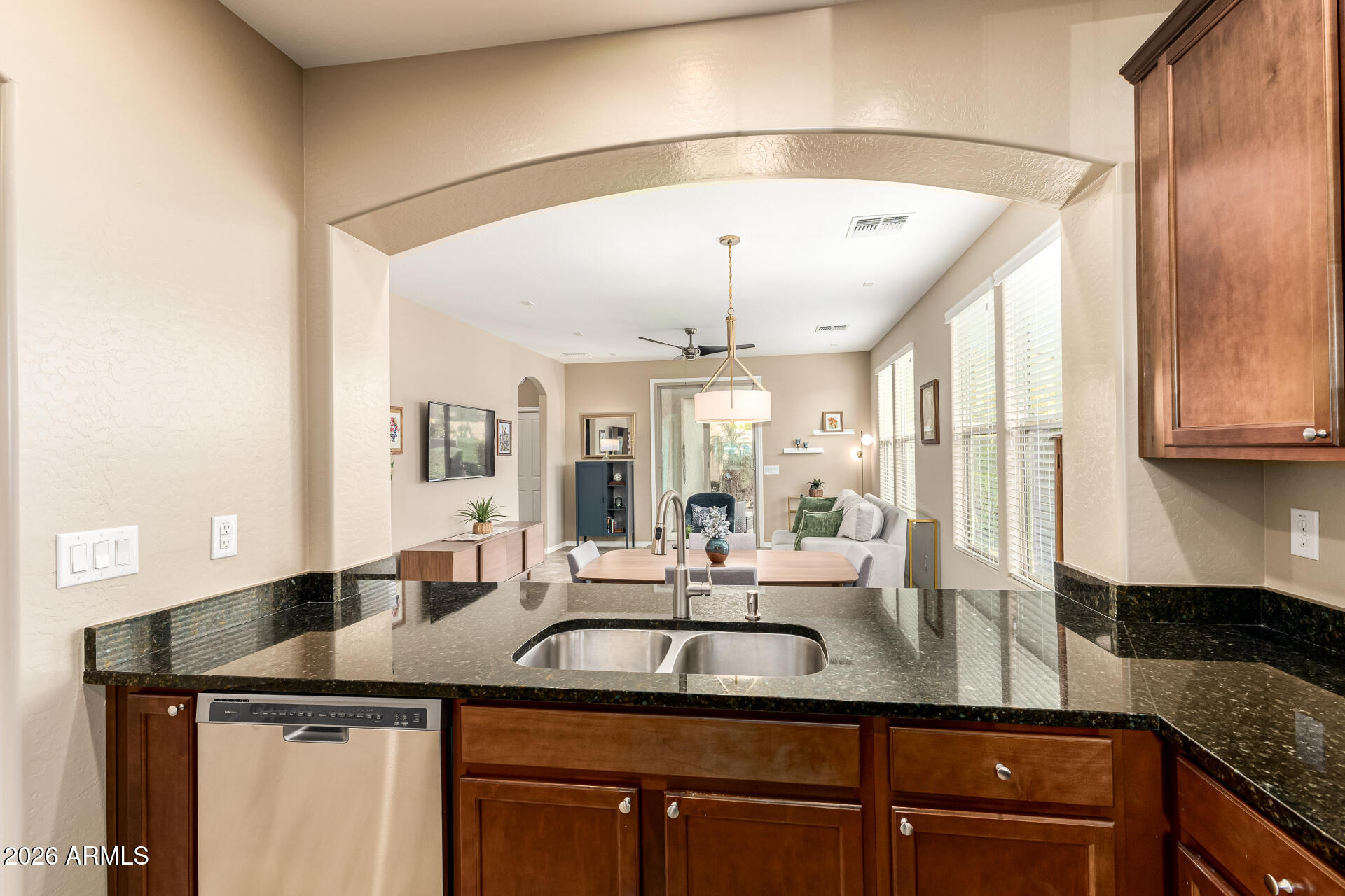 20594 West White Rock Road Buckeye, AZ 85396 - Photo 9 of 38 a kitchen with stainless steel appliances granite countertop a sink and a refrigerator