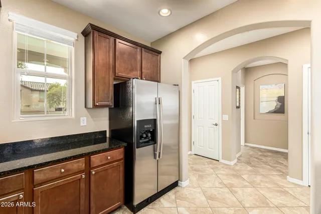 a kitchen with stainless steel appliances granite countertop a refrigerator and a sink