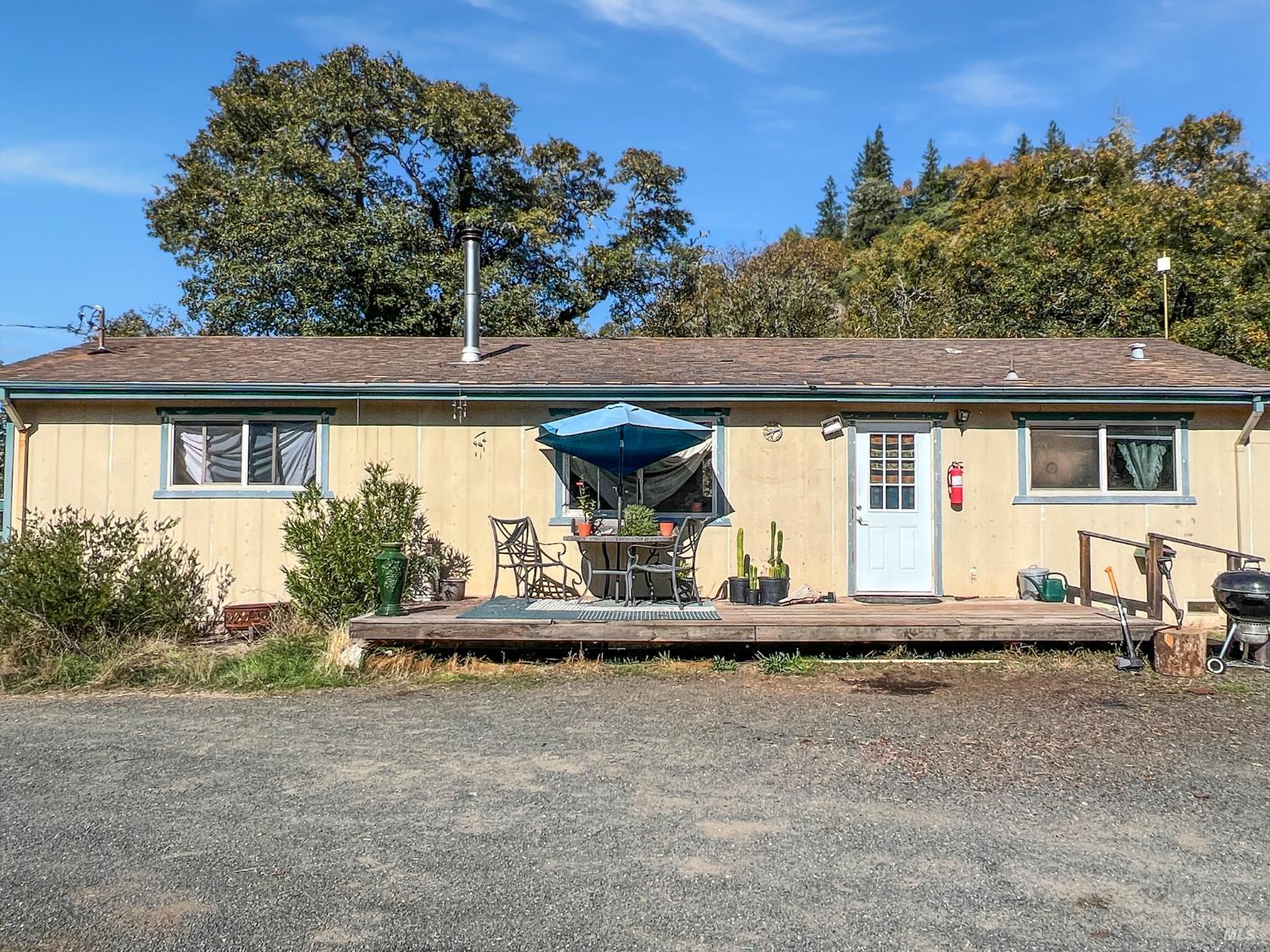 8600 Cave Creek Road Redwood Valley, CA 95470 - Photo 2 of 11 a front view of a house with garden