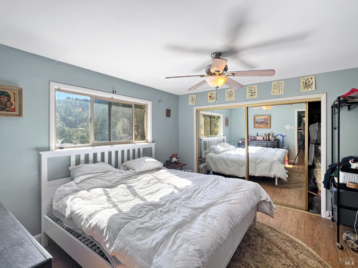 8600 Cave Creek Road Redwood Valley, CA 95470 - Photo 6 of 11 a bedroom with a large bed and a chandelier fan