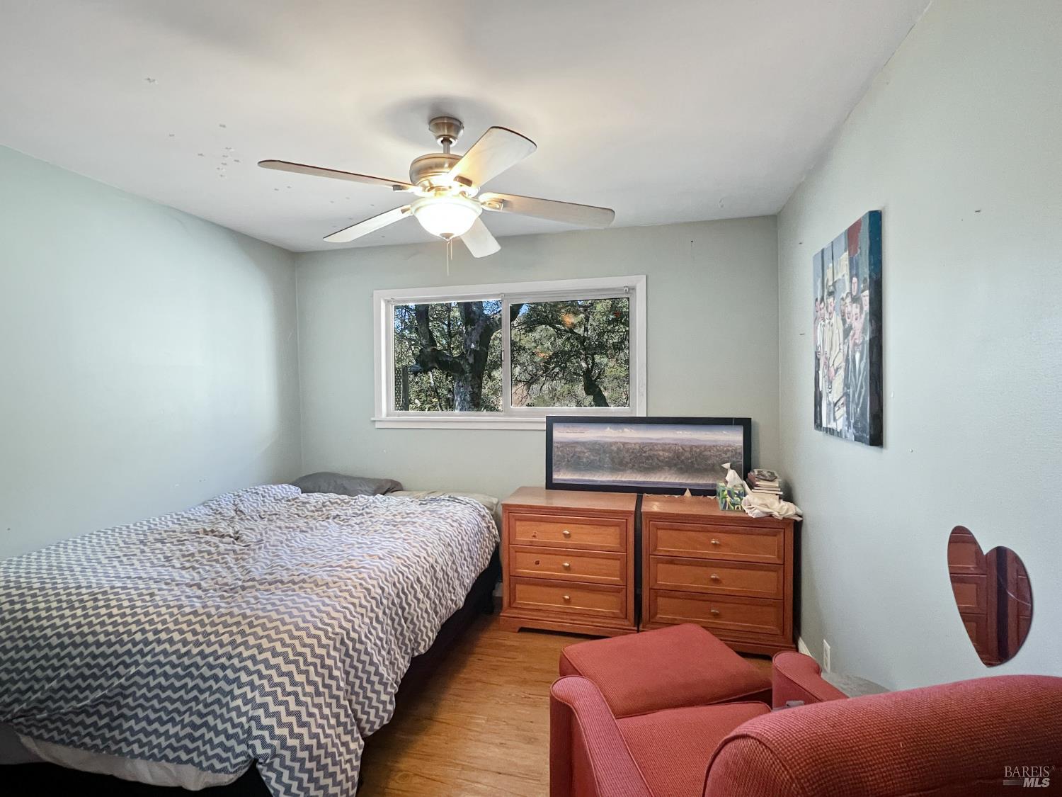 8600 Cave Creek Road Redwood Valley, CA 95470 - Photo 8 of 11 a bedroom with a bed and wooden floor