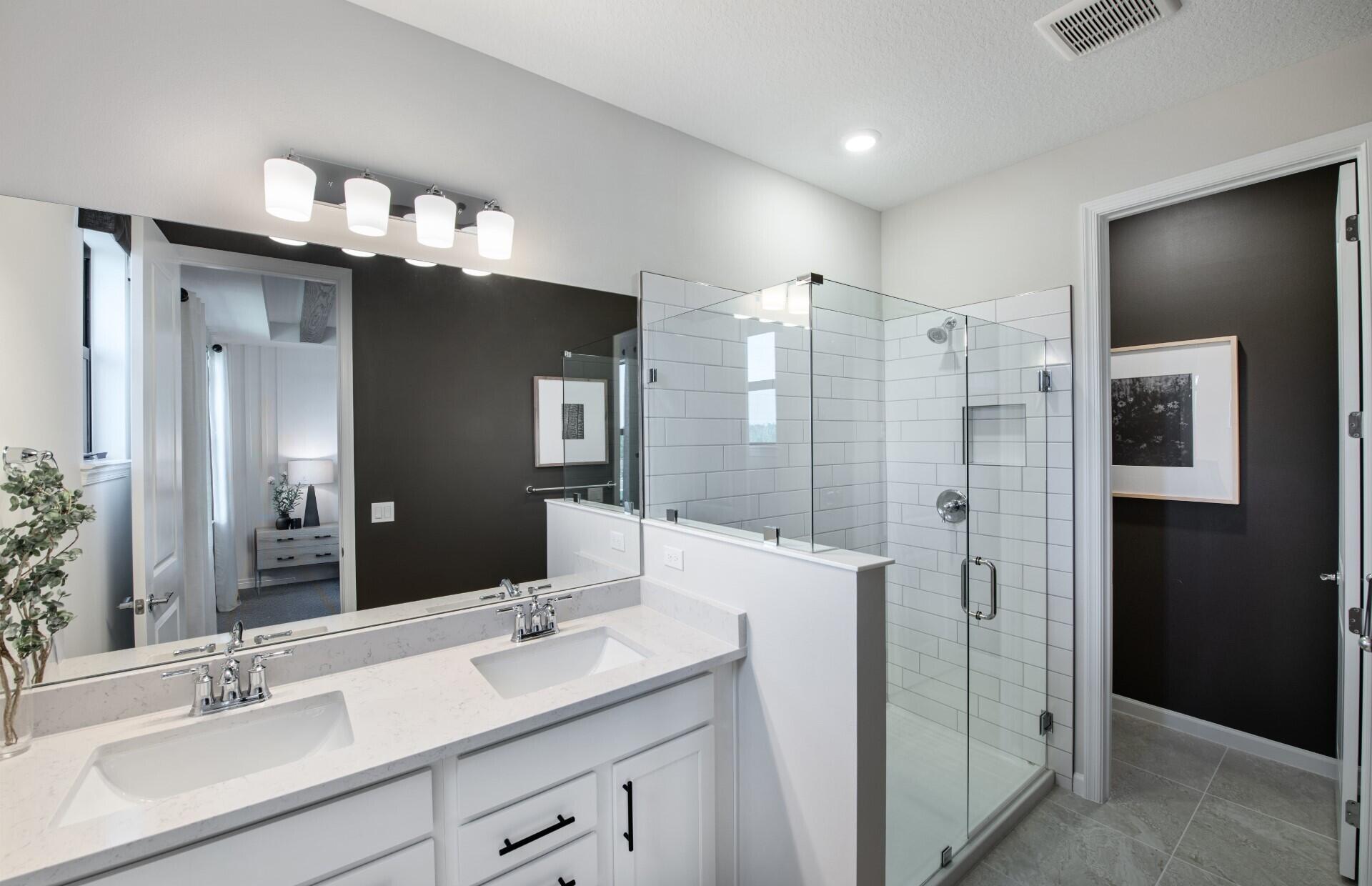 7594 Southwest Linus Lane, Unit LATITUDE 902 Stuart, FL 34997 - Photo 14 of 21 a bathroom with a double vanity sink mirror and shower