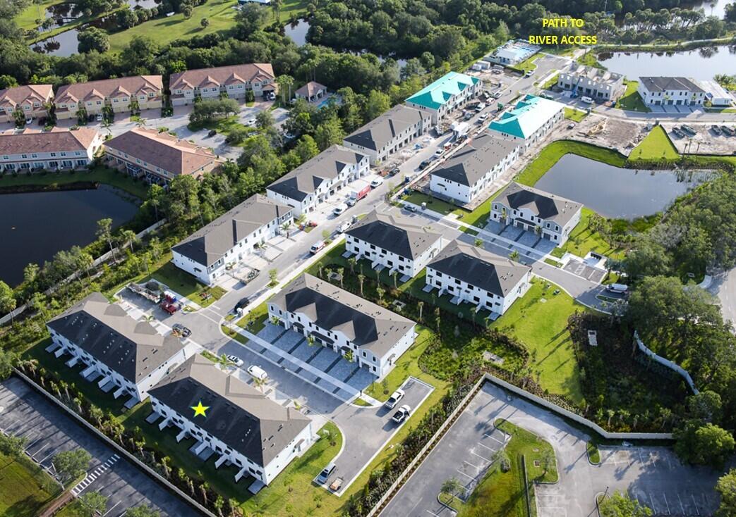 7594 Southwest Linus Lane, Unit LATITUDE 902 Stuart, FL 34997 - Photo 4 of 21 an aerial view of residential house with outdoor space and swimming pool